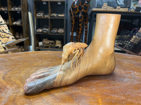 Carved Sculpture of a Mosquito Biting on a Foot