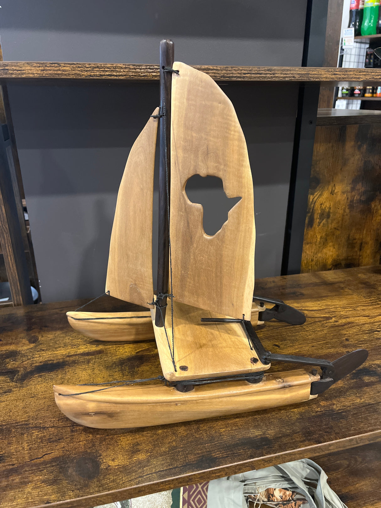 Intricately Hand Carved Wooden Catamaran with ‘Africa’ Sail
