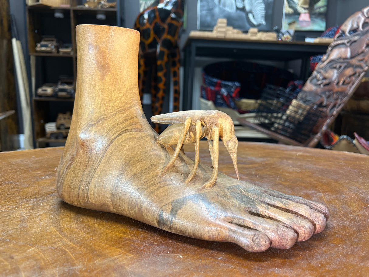 Carved Sculpture of a Mosquito Biting on a Foot