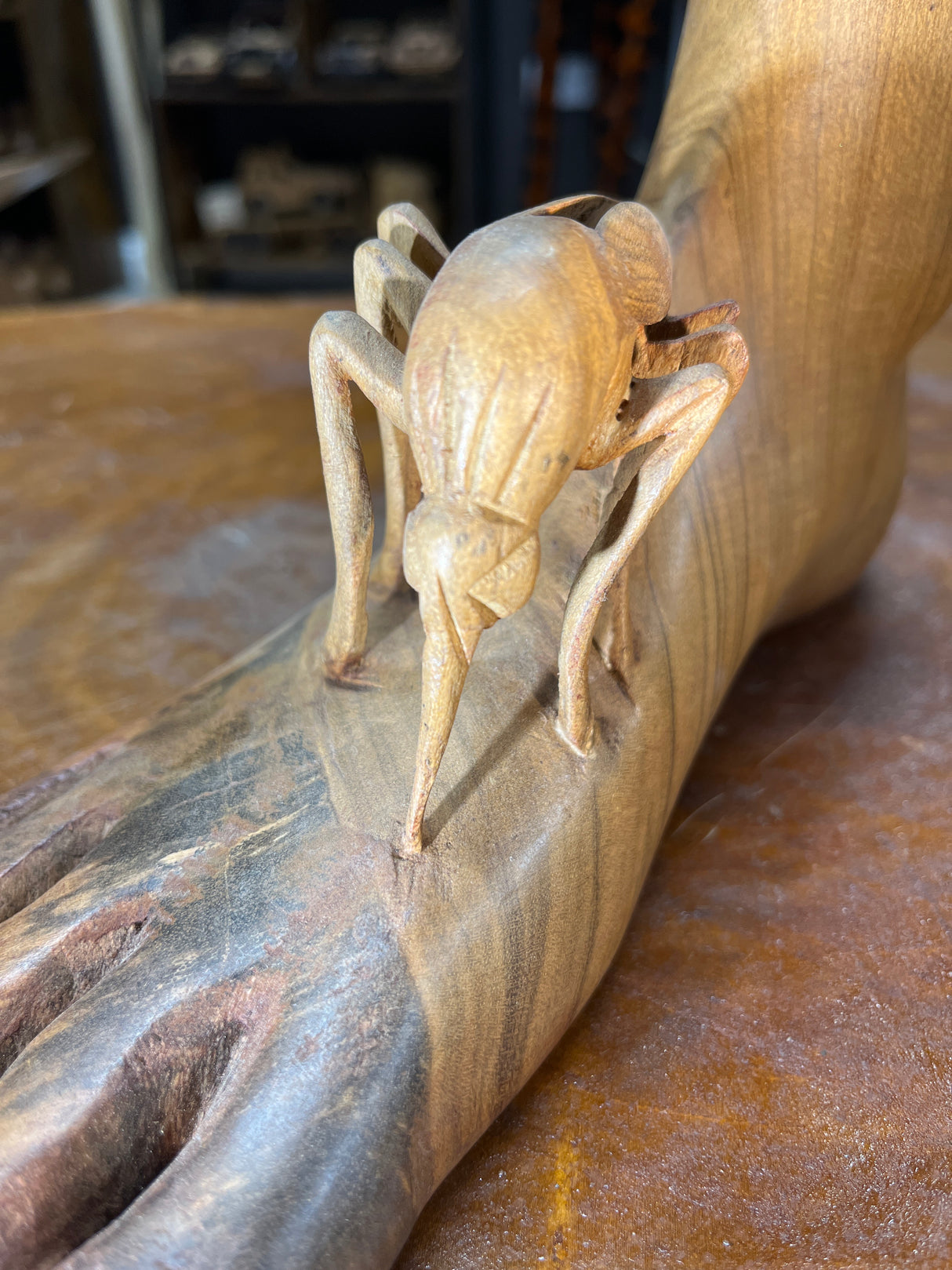 Carved Sculpture of a Mosquito Biting on a Foot